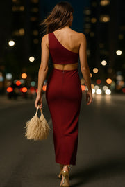 Vestido midi asimétrico de un hombro, fit ajustado, escote diagonal, sin mangas, plisado en costados, abertura lateral en bajo y cut out en espalda. Cierre posterior con cremallera oculta.