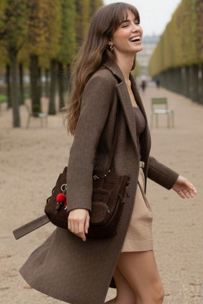 Abrigo largo de manga larga, con solapa, bolsillos delanteros de parche, trabillas y cinturón amarrable del mismo tejido.