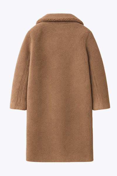 Abrigo largo de borreguillo, fit recto, con solapa, manga larga y bolsillos delanteros con vivos. Cierre frontal con botón en contraste.