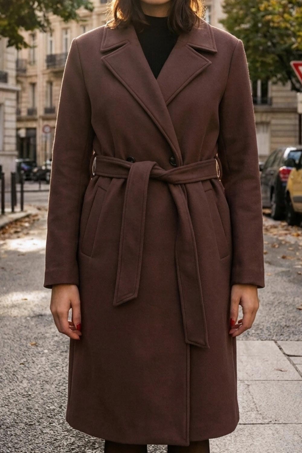 Abrigo largo de fit recto con solapa, manga larga con puños abotonados y bolsillos delanteros con vivos. Cierre frontal con doble cruce de botones. Detalle de abetura posterior en bajo, trabillas y cinturón amarrable del mismo tejido.