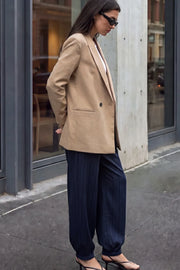 Blazer cruzado de fit oversized, con solapa y hombreras, manga larga, vivo frontal, bolsillos delanteros con cartera. Cierre frontal con cruce de botones.