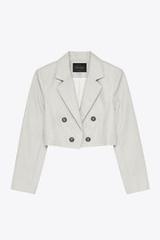 Blazer corto abierto de efecto piel, fit recto, con hombreras y solapa, manga larga y botones decorativos frontales en contraste.