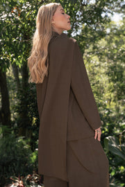 Blazer de fit oversized, con solapa y hombreras, manga larga, bolsillos delanteros con vivos y cierre frontal con botón. Detalle decorativo en cuello.