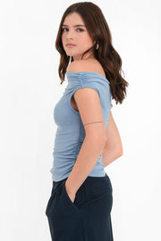 Blusa de fit ajustado, manga corta seguida con plisados en laterales, hombros descubiertos, plisados en costados y escote recto.