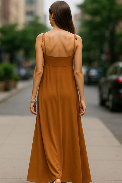 Blusa larga de fit fluido, tirantes delgados con nudo ajustable, escote v con cortes, abertura frontal y cierre con botón.