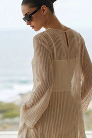 Blusa túnica de cuello redondo, manga larga con puño amplio, bajo frontal asimétrico, corte en a, cierre posterior con botón y ojal. Detalle de rayas contraste en tejido.