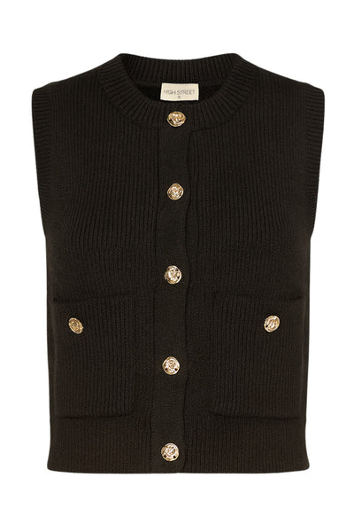 Chaleco corto de punto, fit recto, bolsillos frontales con botón, rib en puños, bajo y cuello redondo. Cierre frontal con hilera de botones en contraste.