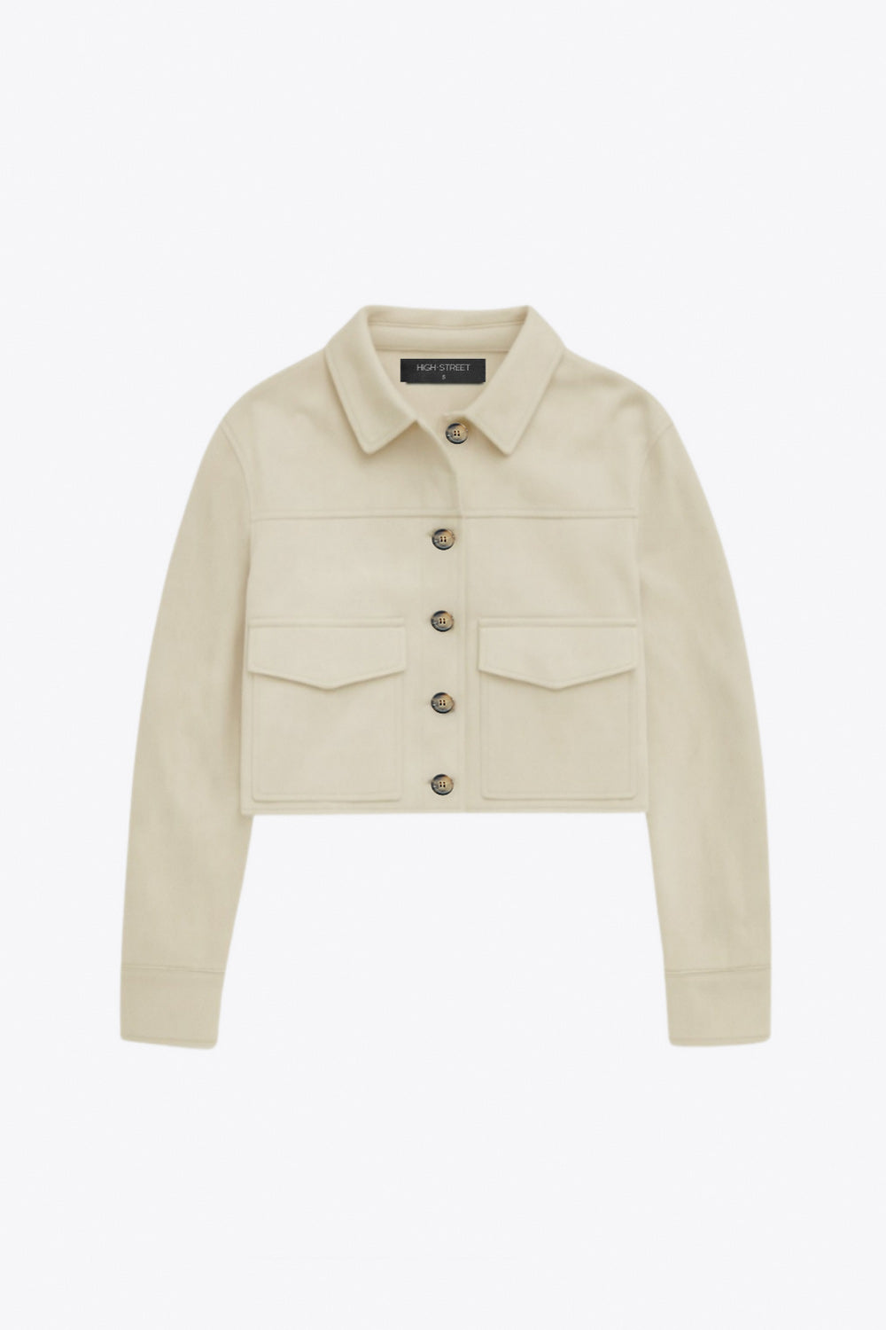 Chamarra corta fluida de gamuza, manga larga con puño abotonado, cuello camisero, bolsillos frontales de parche y cierre frontal con hilera de botones en contraste.