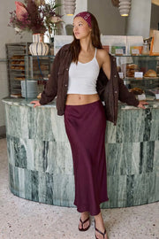 Falda midi satinada de cintura alta con pretina elástica y fit recto.