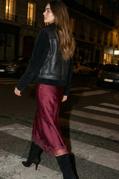 Falda midi satinada de cintura alta con pretina elástica y fit recto. Detalle de encaje en bajo.