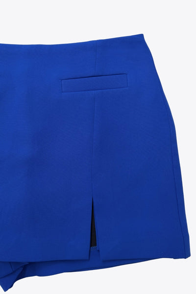 Falda short de fit ajustado cintura alta, vivos decorativos frontales, abertura en bajo y cierre posterior con cremallera oculta.