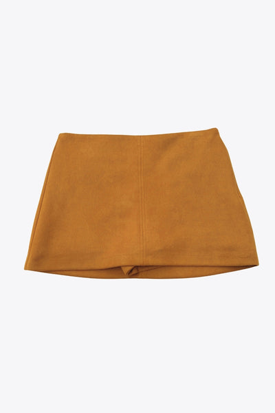 Falda short corto de gamuza, fit ajustado, cintura alta, costura frontal y posterior. Cierre lateral con cremallera oculta.