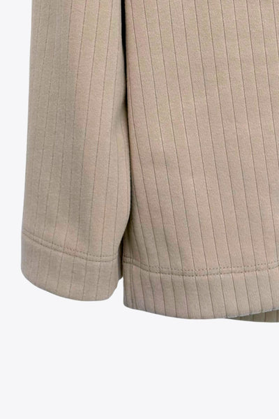 Jersey canalé de punto, fit oversized, cuello alto con doblez y manga larga.