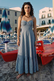 Maxi vestido de corte en a, estampado rayas, tirantes delgados con nudo amarrable, escote corazón con cortes y detalles plisados. Cierre posterior con cremallera visible en contraste y olanes en borde de bajo.
