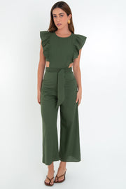 Palazzo de fit culotte, cintura con cut-out en costado, cuello redondo, sin mangas, detalle de olanes en hombros, lazo posterior amarrable en cintura y cierre posterior con cremallera visible en contraste.