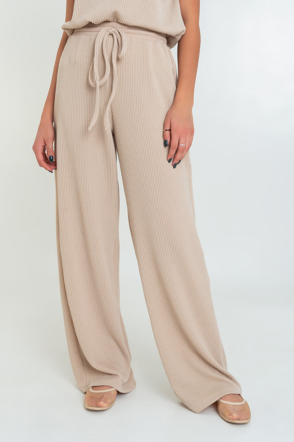 Pantalón canalé de fit wide leg, cintura alta con pretina elástica y jareta frontal ajustable.