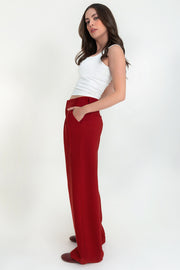 Pantalón de fit wide leg, pinzas frontales, cintura alta con pretina y trabillas, bolsillos delanteros, cierre frontal con broche y cremallera ocultos.