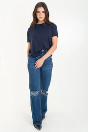 Pantalón wide leg de denim con rotos, tiro alto, bolsillos delanteros y traseros de parche. Cierre con botón y cremallera oculta. Detalle de rotos en bajo.