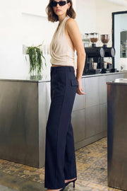 Pantalón de fit recto, cintura media con pretina y trabillas, bolsillos delanteros y posteriores con cartera, detalle de raya frontal y posterior. Cierre con broche y cremallera ocultos.