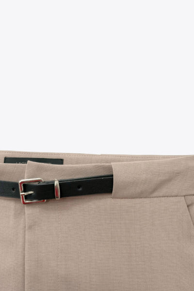 Pantalón de fit recto, cintura alta con pretina y trabilla ancha, bolsillos delanteros y vivos decorativos posteriores. Cierre frontal con broche y cremallera ocultos. Detalle de cinturón con hebilla en contraste.