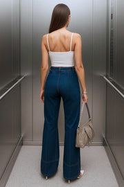 Pantalón de denim, fit flare, cintura alta con pretina y trabillas, cinturón del mismo tejido con hebilla en contraste y detalle de raya central con costuras decorativas en bajo. Cierre frontal con botón y cremallera oculta.