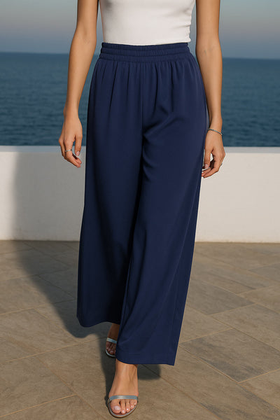 Pantalón fluido de fit wide leg, cintura alta elástica y bolsillos delanteros.