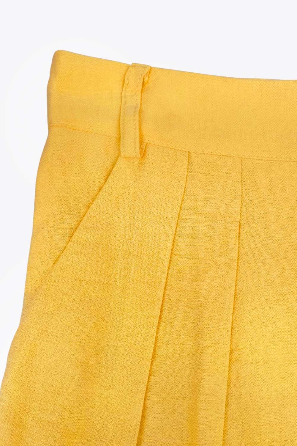 Pantalón de fit wide leg, cintura alta con pretina y trabillas, pinzas frontales, bolsillos delanteros, cierre frontal con broche y cremallera ocultos.