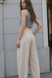 Pantalón fit balloon, de cintura alta con pretina ancha, bolsillos delanteros, pinzas frontales con detalle decorativo, cierre frontal con broche y cremallera ocultos.