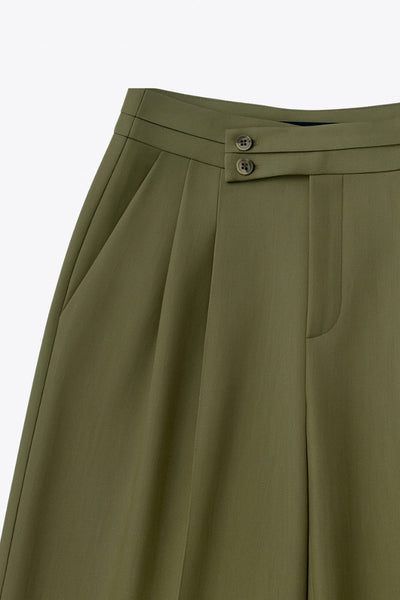 Pantalón de fit wide leg, cintura alta con pretina criss cross y detalle decorativo, pinzas frontales, bolsillos delanteros, cierre frontal con botones en contraste y cremallera oculta.