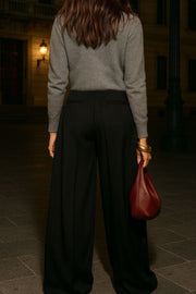 Pantalón de fit wide leg, cintura alta, pinzas frontales con raya, vivos decorativos posteriores, cierre frontal con broche y cremallera ocultos.