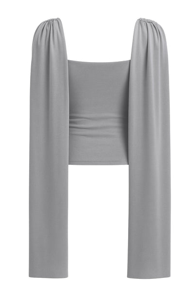 Top de fit ajustado, sin mangas, cuello redondo y detalle decorativo frontal con plisados en hombros.