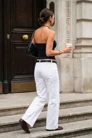 Top corto strapless, fit ajustado, escote corazón con nudo frontal y plisados decorativos.