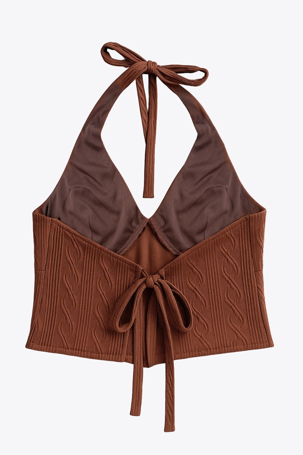 Top corto de cuello halter, lazo amarrable posterior, escote v con cortes frontales, bajo v frontal, escote en espalda y lazo amarrable posterior. Detalle de textura en tejido.