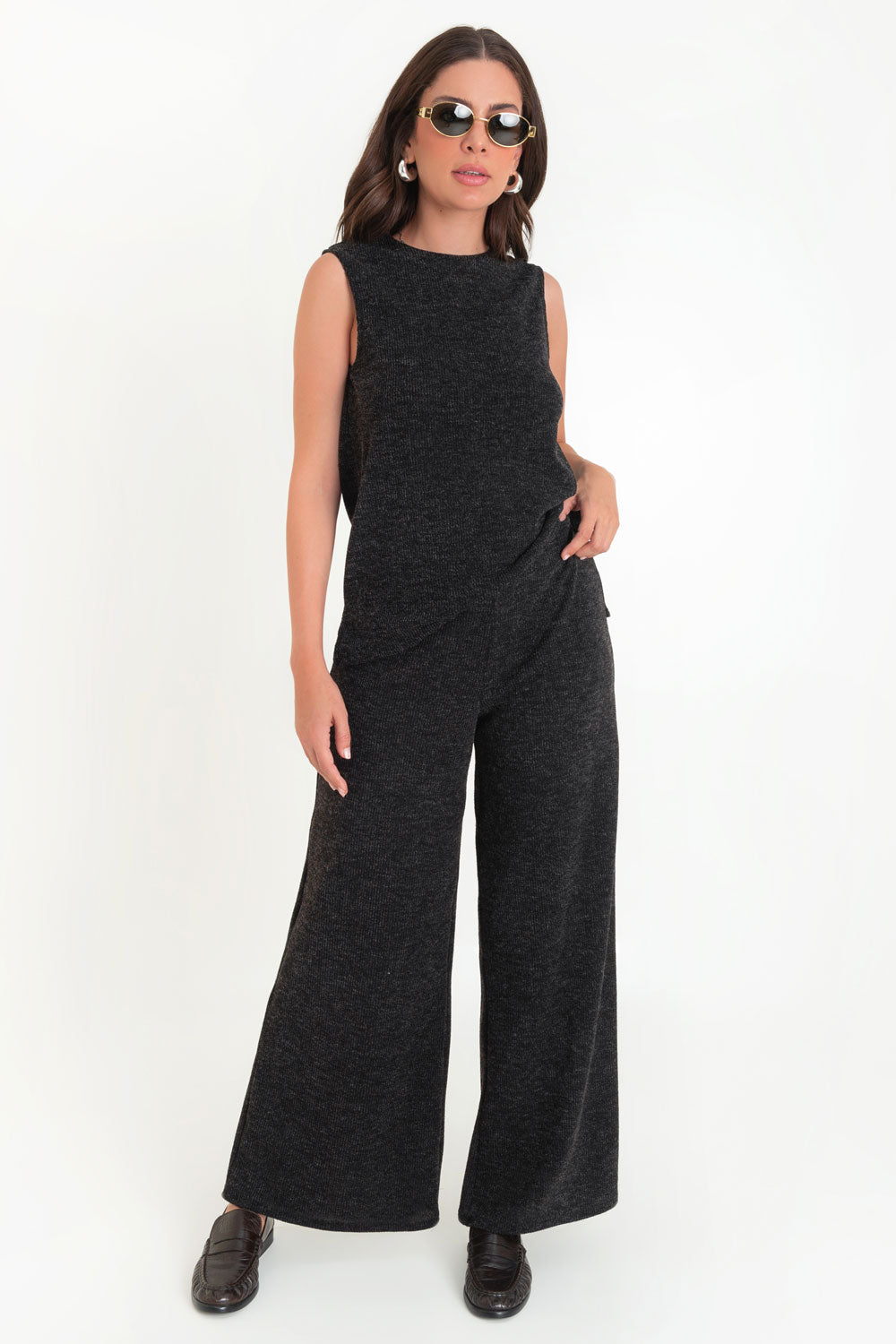 Top canalé de tejido de punto, fit ligeramente oversized, cuello redondo, sin mangas y aberturas laterales en bajo.

Pantalón canalé de tejido de punto, fit wide leg y cintura alta con pretina elástica.