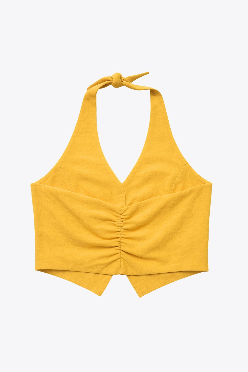 Top corto de cuello halter con nudo amarrable posterior, fit ajustado, escote v, cierre frontal con hilera de botones y bajo v frontal. Escote en espalda y detalle de plisado posterior.