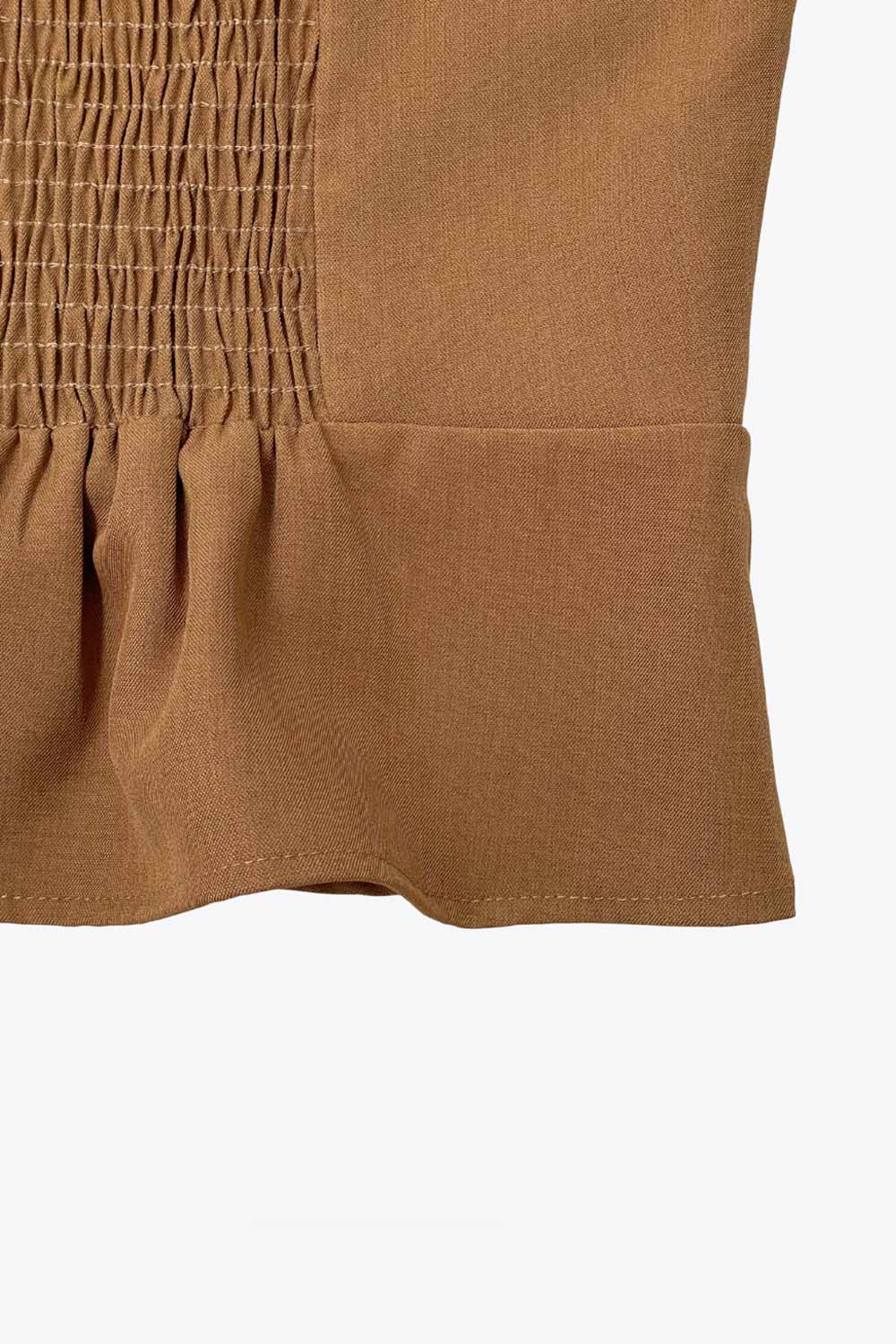 Top corto de cuello halter con nudo amarrable posterior, escote v con cortes y plisados decorativos frontales, fit ajustado, escote en espalda con fruncido posterior, cierre frontal con hilera de botones y bajo curveado con abertura.