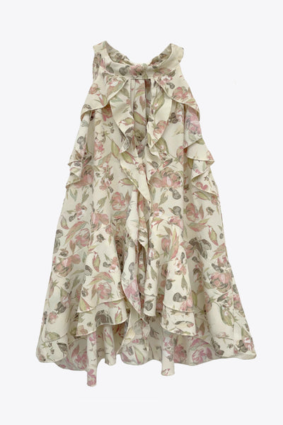 Blusa de fit fluido, estampado floral, sin mangas, cuello halter, capas de olanes frontales y en bajo asimétrico. Cierre posterior con lazo amarrable.