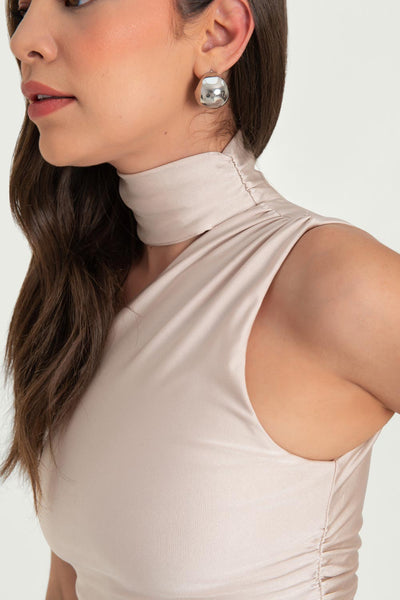 Top satinado asimétrico, de fit ajustado, detalles plisados laterales y en hombro, sin mangas, un hombro, escote diagonal y choker con plisados. Cierre posterior con botón y ojal.