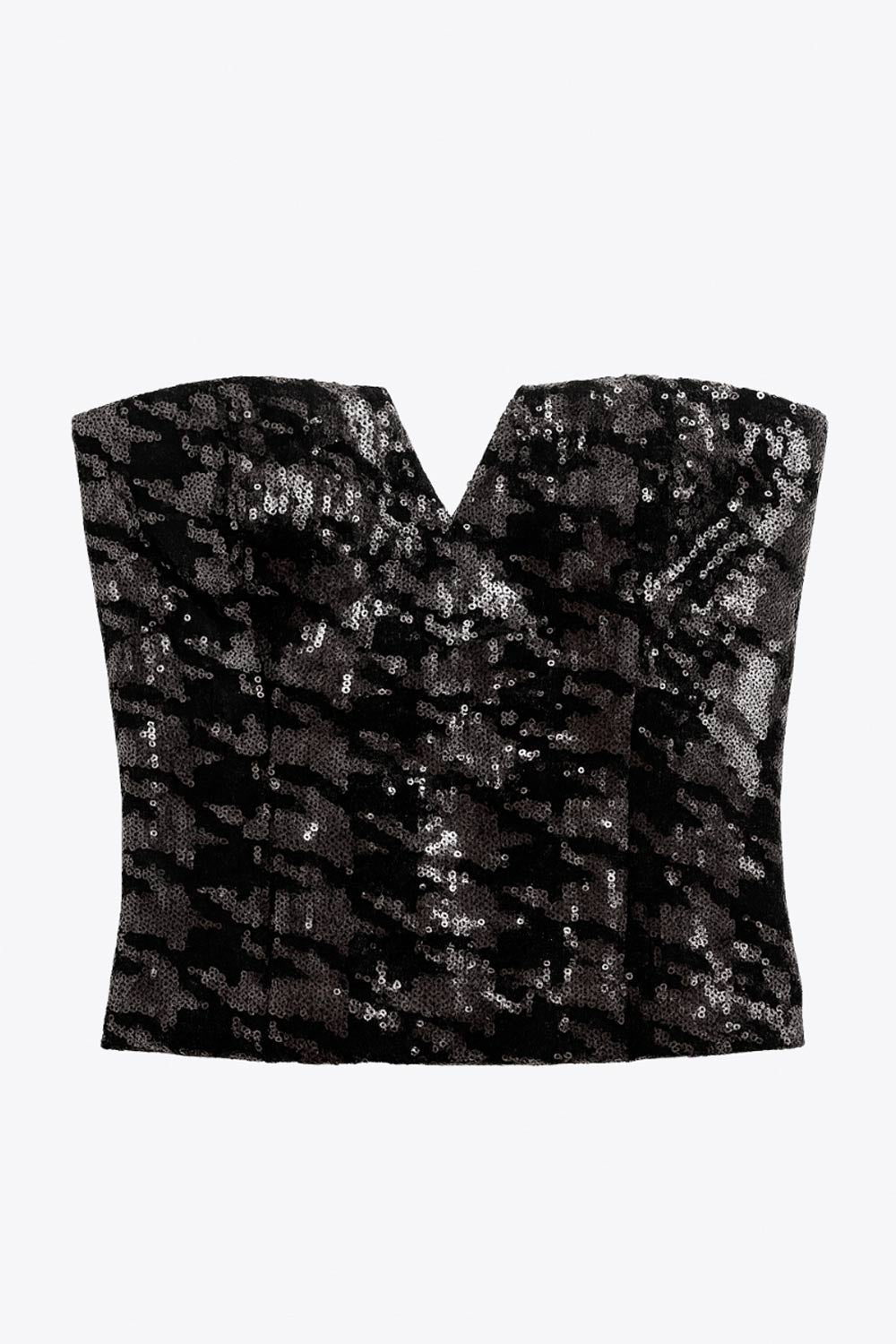 Crop top strapless de lentejuelas, estampado pata de gallo, escote corazón con detalle en v, cortes frontales y cierre posterior con cremallera visible en contraste.