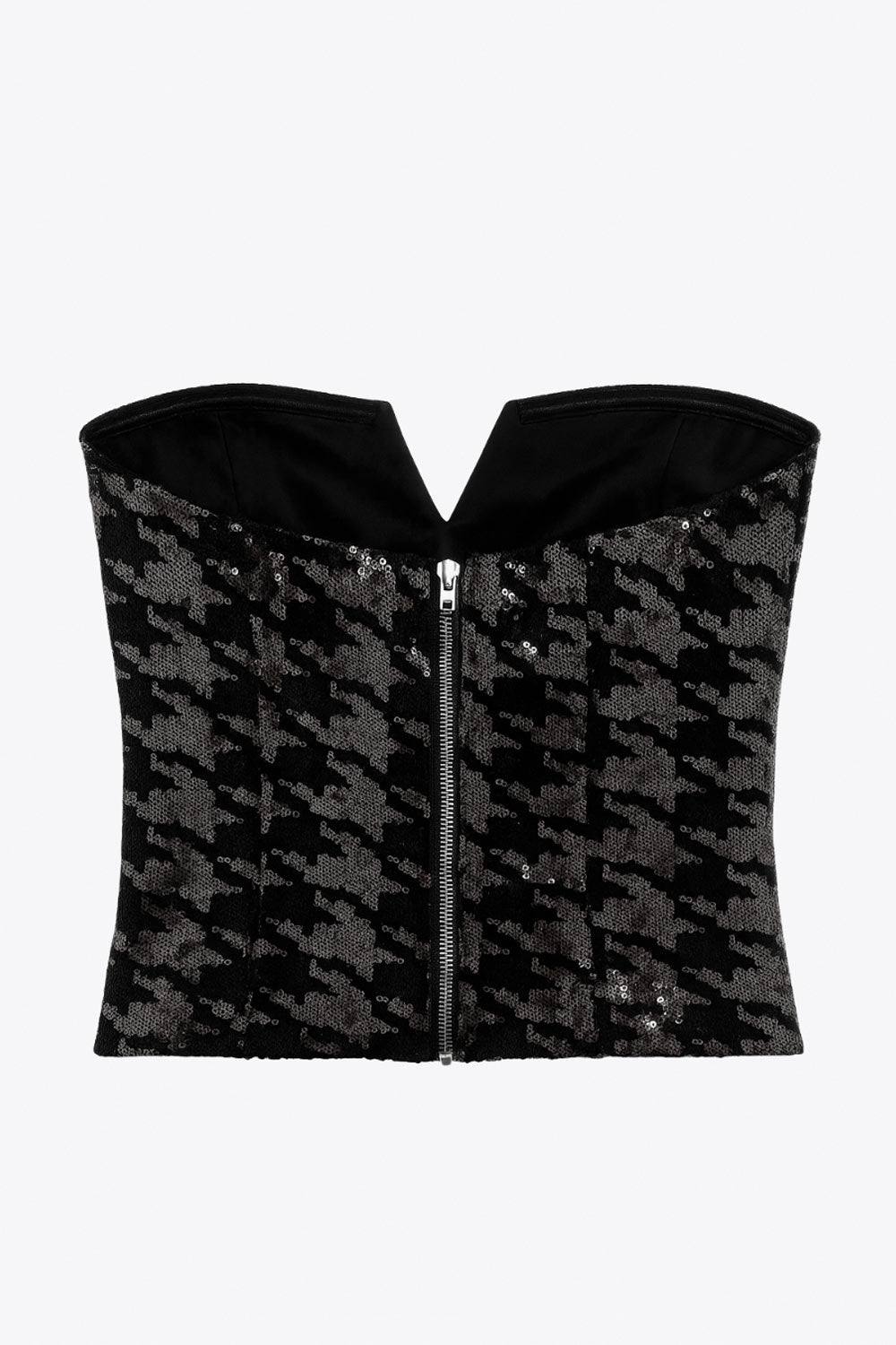 Crop top strapless de lentejuelas, estampado pata de gallo, escote corazón con detalle en v, cortes frontales y cierre posterior con cremallera visible en contraste.