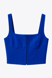 Top corset corto de fit ajustado, sin mangas, escote cuadrado con cortes decorativos frontales y cierre frontal con hilera de broches ocultos.
