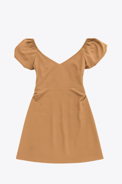 Vestido corto de fit ajustado, manga corta abullonada con rib elástico en bordes, corte en cintura, cut out en espalda con doble elástico plisado y cierre posterior con cremallera oculta.