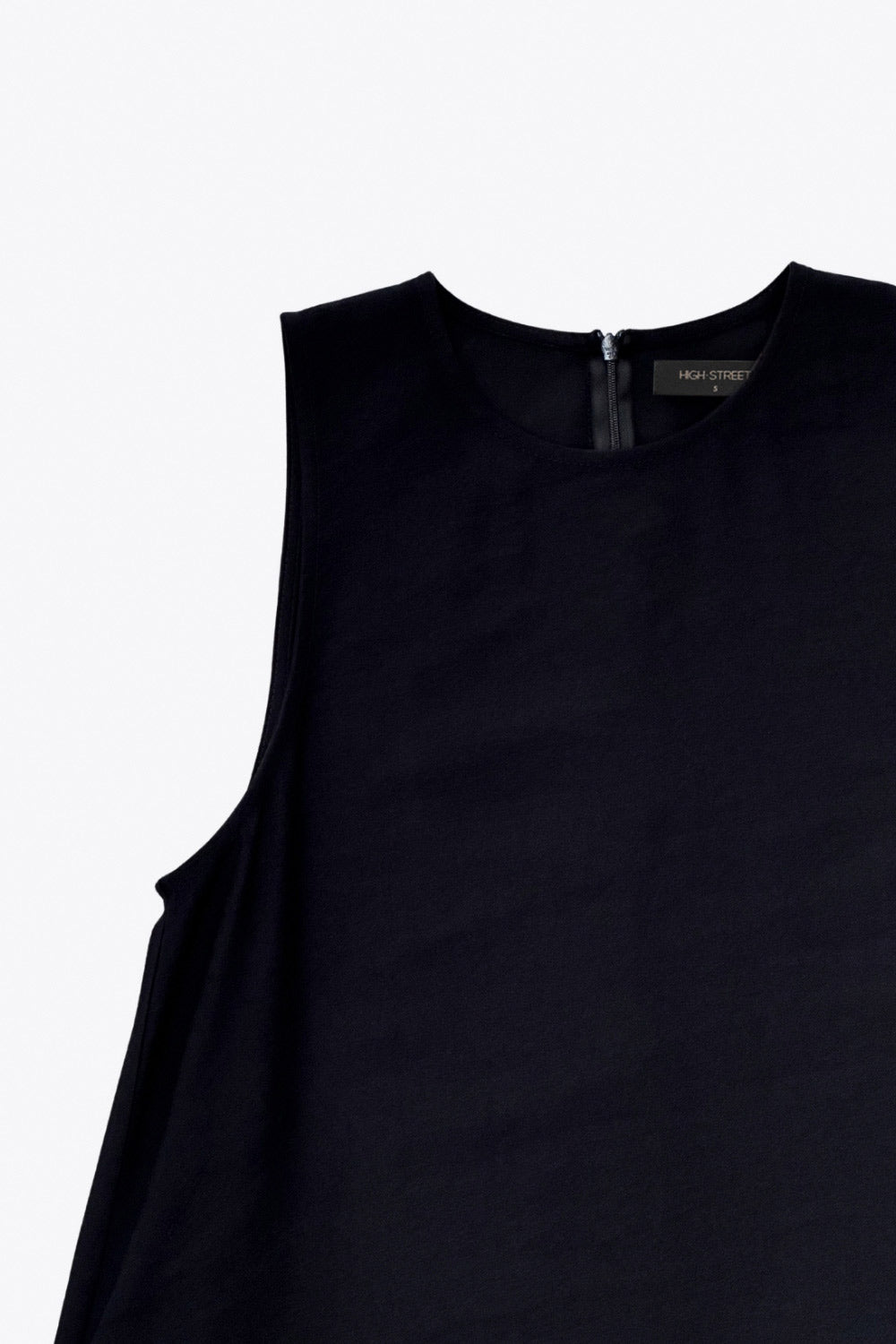 Vestido midi básico de fit fluido, corte en a, sin mangas, bolsillos delanteros y cuello redondo. Cierre posterior con botón y ojal.