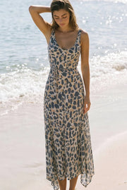 Vestido midi de corte en a, estampado animal, sin mangas, escote v con cortes frontales decorativos, bajo asimétrico con olanes, escote fluido en espalda y lazo amarrable en cintura.