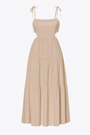 Vestido midi de lino, corte en a, tirantes delgados con nudo amarrable, bajo con capas de olanes, cut out en costados y espalda. Detalle de rib elástico en cintura y fruncido en espalda.