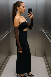 Vestido largo strapless, de fit ajustado, escote recto, cut out decorativo frontal y cierre posterior con cremallera visible en contraste. Detalle de abertura posterior en bajo y mangas decorativas de mesh en contraste.