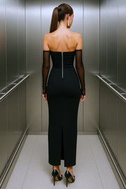 Vestido largo strapless, de fit ajustado, escote recto, cut out decorativo frontal y cierre posterior con cremallera visible en contraste. Detalle de abertura posterior en bajo y mangas decorativas de mesh en contraste.